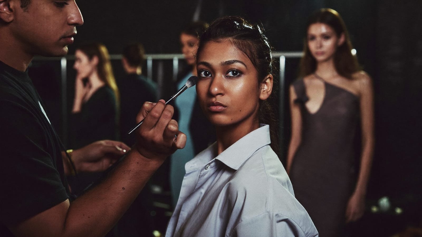 Makeup artist packing a professional kit bag before an on-location bridal appointment