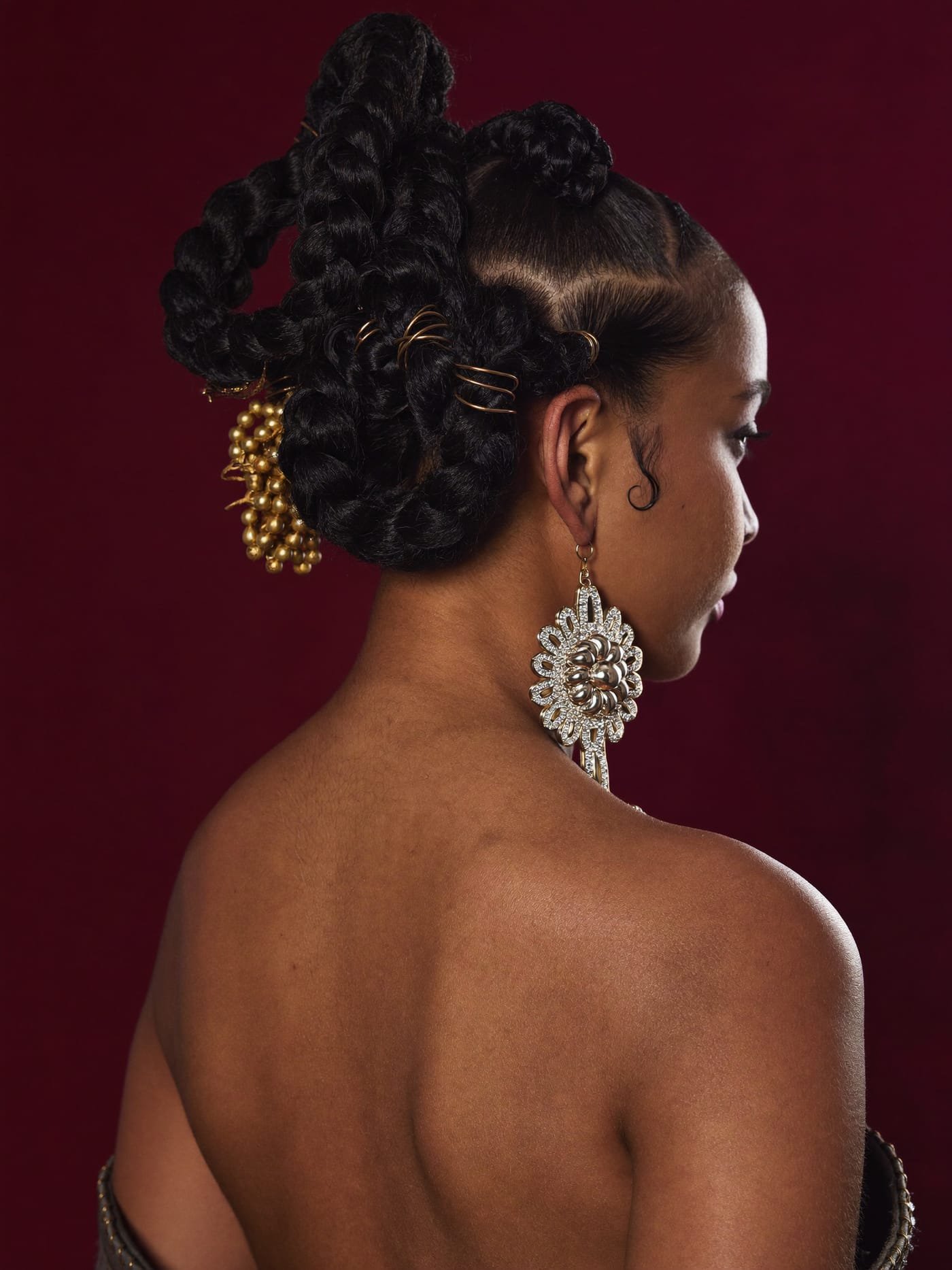 Sculptural braided updo with gold accessories