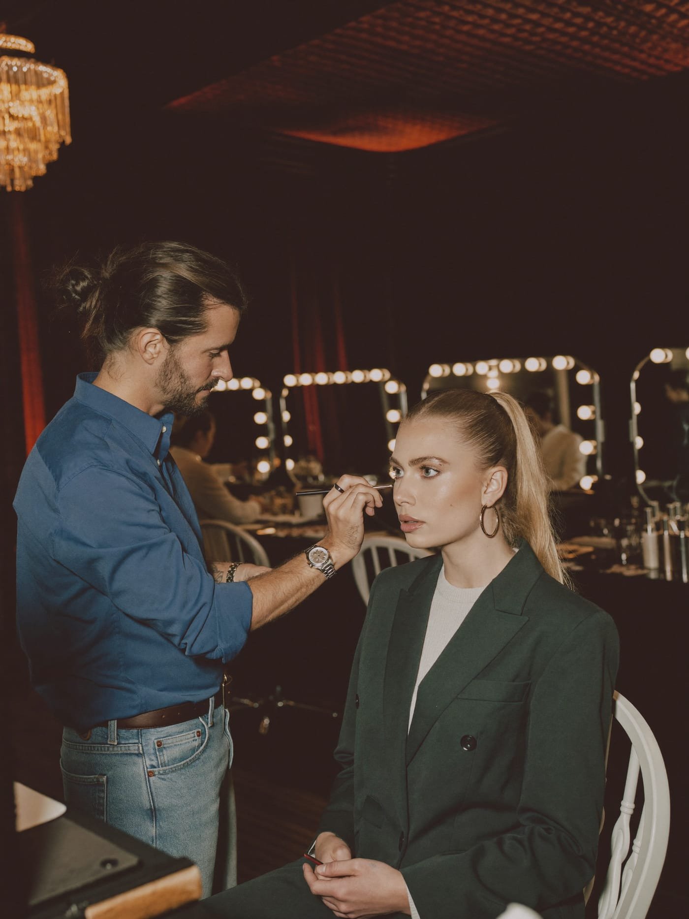 Instructor perfecting a student's editorial makeup look in the Red Fox studio